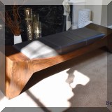 F05. Wood and leather bench. 16” x 69”w 